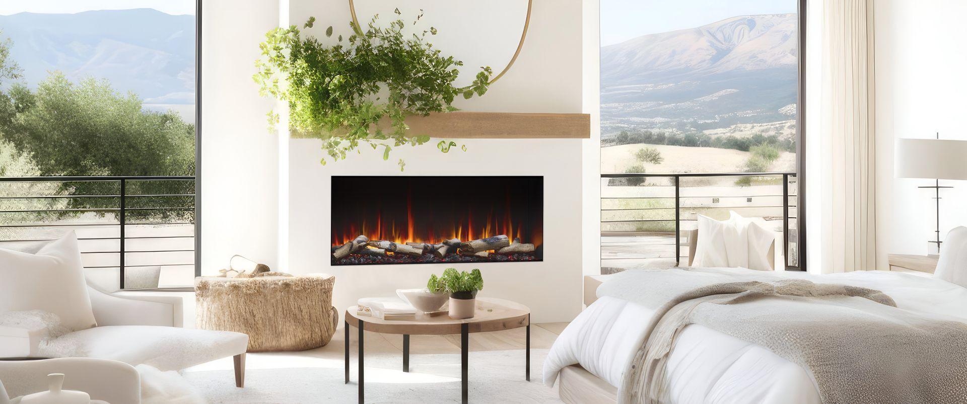 Linear electric fireplace in a bedroom with windows facing the mountains